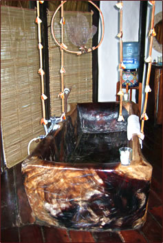 Azulik EcoTulum Resorts cottage interior with zapote log bathtub.