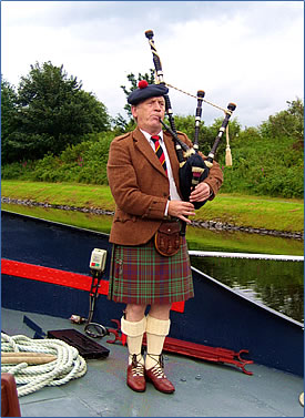 Scottish bagpiper visits European Waterways Scottish Highlander luxury barge.