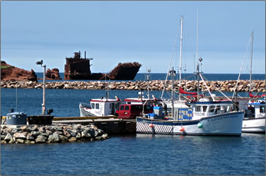 Shipwreck and fishing boats: Quebec's Les Îles de la Madeleine, Magdalen Islands.
